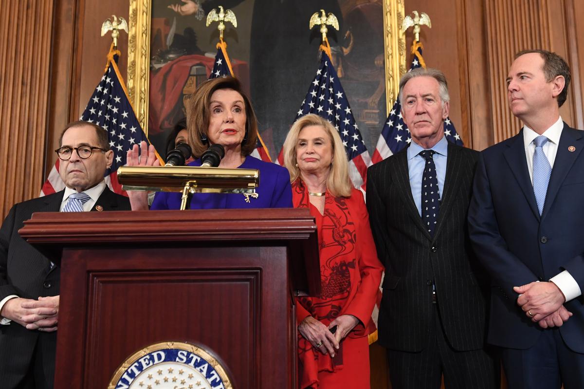 House Speaker Nancy Pelosi (D-Calif.), (Front C), flanked by House Intelligence Chairman Adam Schiff (D-Calif.) (R), House Judiciary Chairman Jerry Nadler (D-N.Y.) (L), House Financial Services Committee Chairwoman Maxine Waters (D-Calif.) (2nd L), House Committee on Oversight and Reform Chairwoman Carolyn Maloney (D-N.Y.) (C), and House Ways and Means Chairman Richard Neal (D-Mass.) (2nd R), speaks as Democrats announced articles of impeachment against President Donald Trump during a press conference at the U.S. Capitol in Washington, on Dec. 10, 2019. (Saul Loeb/AFP via Getty Images)