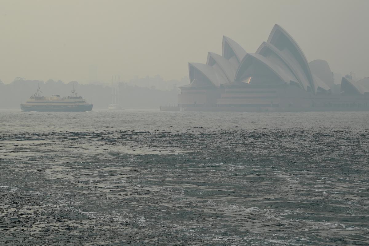 The Sydney Opera House can be seen as smoke haze from bushfires in New South Wales blankets the CBD in Sydney, Australia, on Dec. 10, 2019. (AAP Image/Joel Carrett/via Reuters)