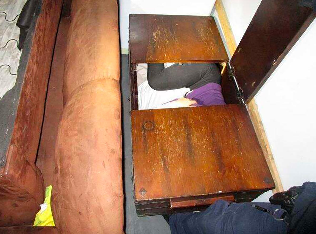 This photo released on Dec. 9, 2019 by U.S. Customs and Border Protection (CBP) shows a person hiding inside a wooden chest, among 11 Chinese nationals found by CBP agents hiding in furniture and appliances inside a moving truck stopped on Dec. 7, while entering the U.S. from Mexico at the San Ysidro border crossing near San Diego, federal officials said. (U.S. Customs and Border Protection via AP)