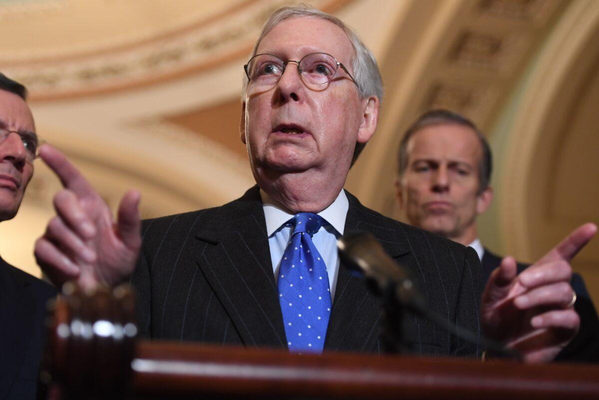 Senate Majority Leader Mitch McConnell (R-Ky.) speaks during a press conference at the US Capitol in Washington on Dec. 10, 2019. Sen. John Thune (R-S.D.) and Sen. John Barrasso (R-Wyo.) are in the background. (Saul Loeb/AFP via Getty Images)