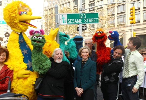 (L-R) Puppeteer Caroll Spinney, Sesame Street co-founder and TV producer Joan Ganz Cooney, and Sesame Street cast members pose under a "123 Sesame Street" sign at the "Sesame Street" 40th Anniversary temporary street renaming in Dante Park in New York City on Nov. 9, 2009. (Astrid Stawiarz/Getty Images)