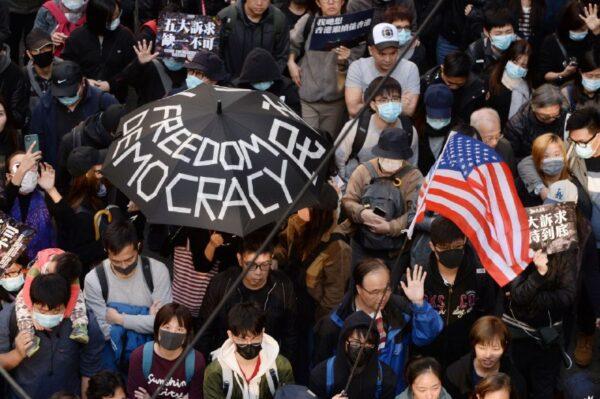 Protesters hold banners and signs in a Hong Kong march on Dec. 8, 2019. (Sung Pilung/The Epoch Times)