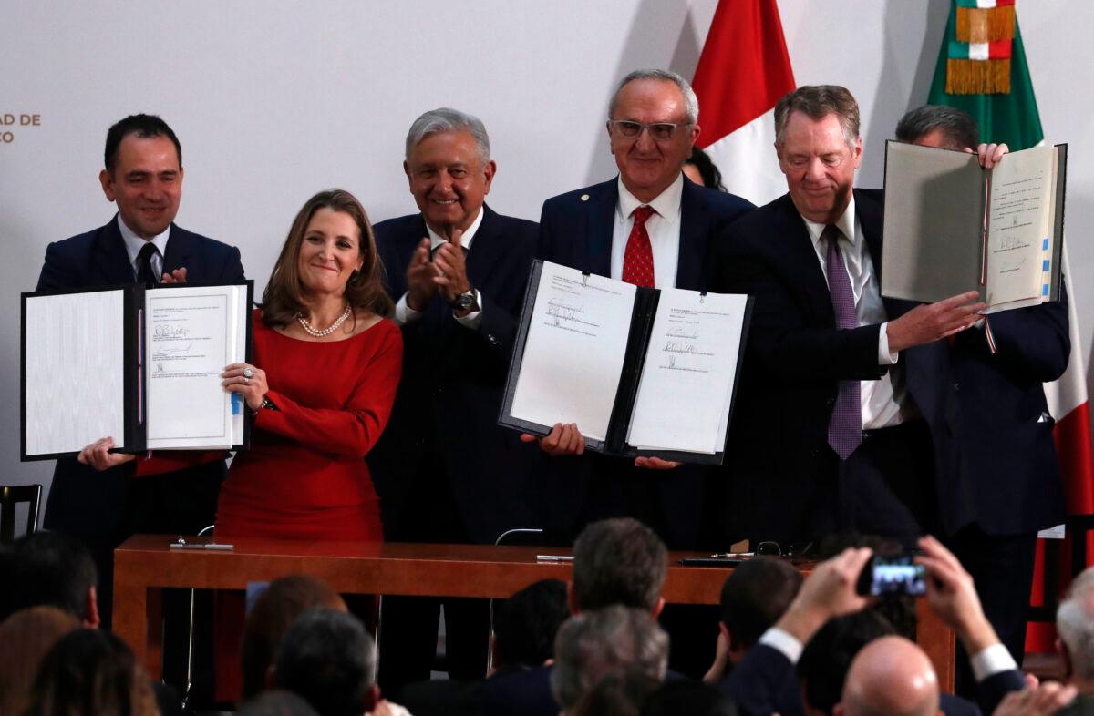 Mexico's Treasury Secretary Arturo Herrera, left, Deputy Prime Minister of Canada Chrystia Freeland, second left, Mexico's President Andrés Manuel López Obrador, center, Mexico's top trade negotiator Jesus Seade, second right, and U.S. Trade Representative Robert Lighthizer, hold the documents after signing an update to the North American Free Trade Agreement, at the national palace in Mexico City, Mexico, on Dec. 10. 2019. (Marco Ugarte/AP Photo)