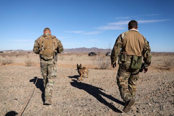 Border Patrol BORSTAR agent Mike Bailey (L) and Supervisory agent Chad Smith with K-9 Zita during a training exercise near the Imperial Sand Dunes, Calif., on Nov. 30, 2019. (Charlotte Cuthbertson/The Epoch Times)