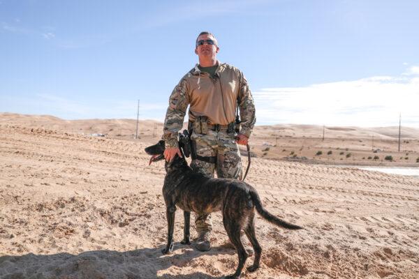 Border Patrol BORSTAR supervisory agent Chad Smith with his K-9 Kyra at the Imperial Sand Dunes, Calif., on Nov. 30, 2019. (Charlotte Cuthbertson/The Epoch Times)