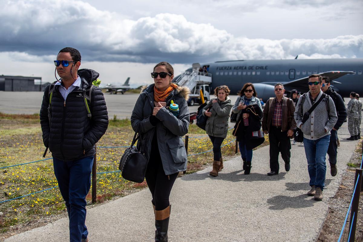 Relatives of passengers on board Chile's Air Force Hercules C-130 aircraft, which crashed over a remote stretch of frigid sea between South America and the Antarctic, arrive from Santiago to an Air Force base in Punta Arenas city, Chile Dec. 11, 2019. (Reuters/Joel Estay)