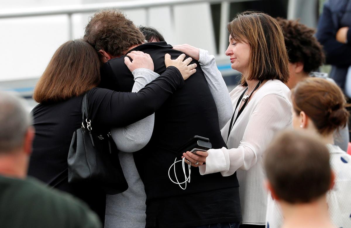 Relatives hug as they wait for rescue mission, following the White Island volcano eruption in Whakatane, New Zealand, on Dec. 13, 2019. (Reuters/Jorge Silva)