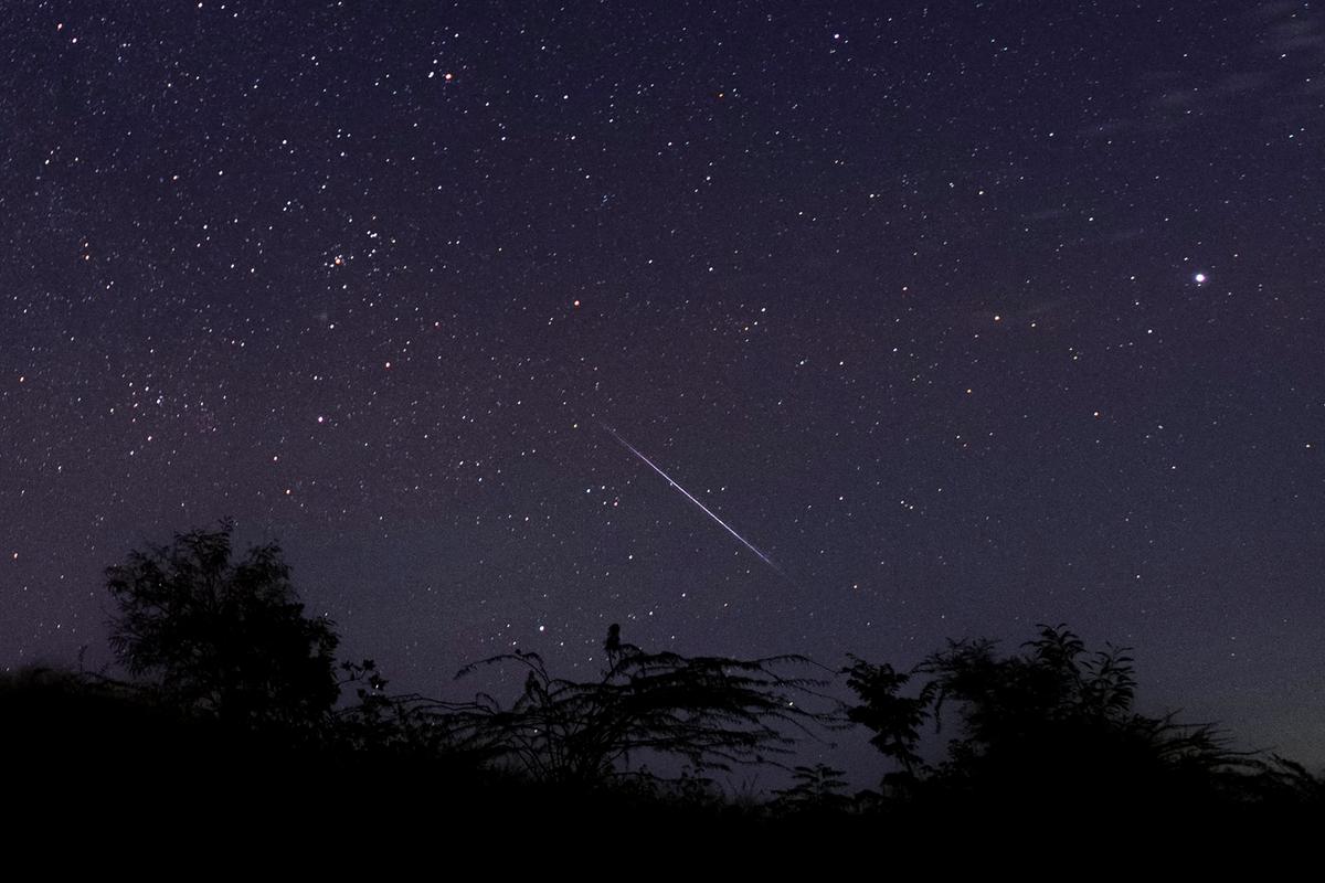 This photo taken late Dec. 14, 2018, with a long-time exposure shows a meteor streaking through the night sky over Myanmar during the Geminid meteor shower seen from Wundwin township near Mandalay City. (©Getty Images | <a href="https://www.gettyimages.com/detail/news-photo/this-photo-taken-late-december-14-2018-with-a-long-time-news-photo/1073354846?adppopup=true">Ye Aung THU</a>)