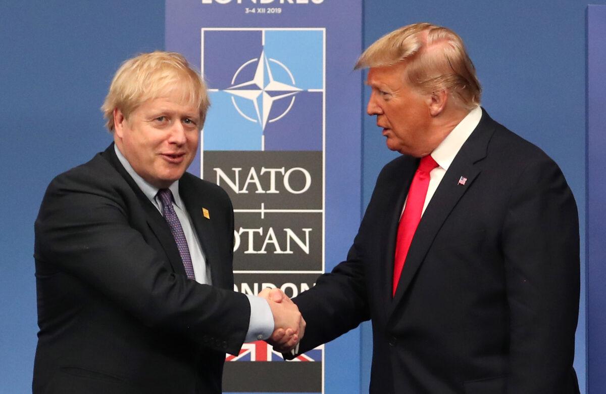 British Prime Minister Boris Johnson shakes hands with U.S. President Donald Trump onstage during the annual NATO heads of government summit in Watford, England, on Dec. 4, 2019. (Steve Parsons-WPA Pool/Getty Images)