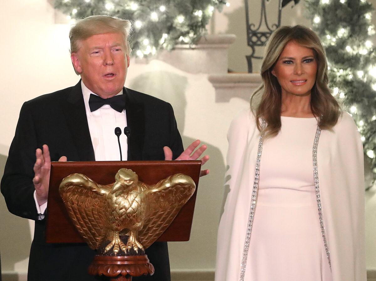 President Donald Trump speaks as First Lady Melania Trump looks on during a Congressional Ball in the Grand Foyer of the White House in Washington on Dec. 12, 2019. (Mark Wilson/Getty Images)