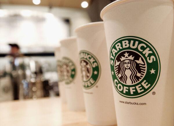 Beverage cups featuring the logo of Starbucks Coffee. (Stephen Chernin/Getty Images)