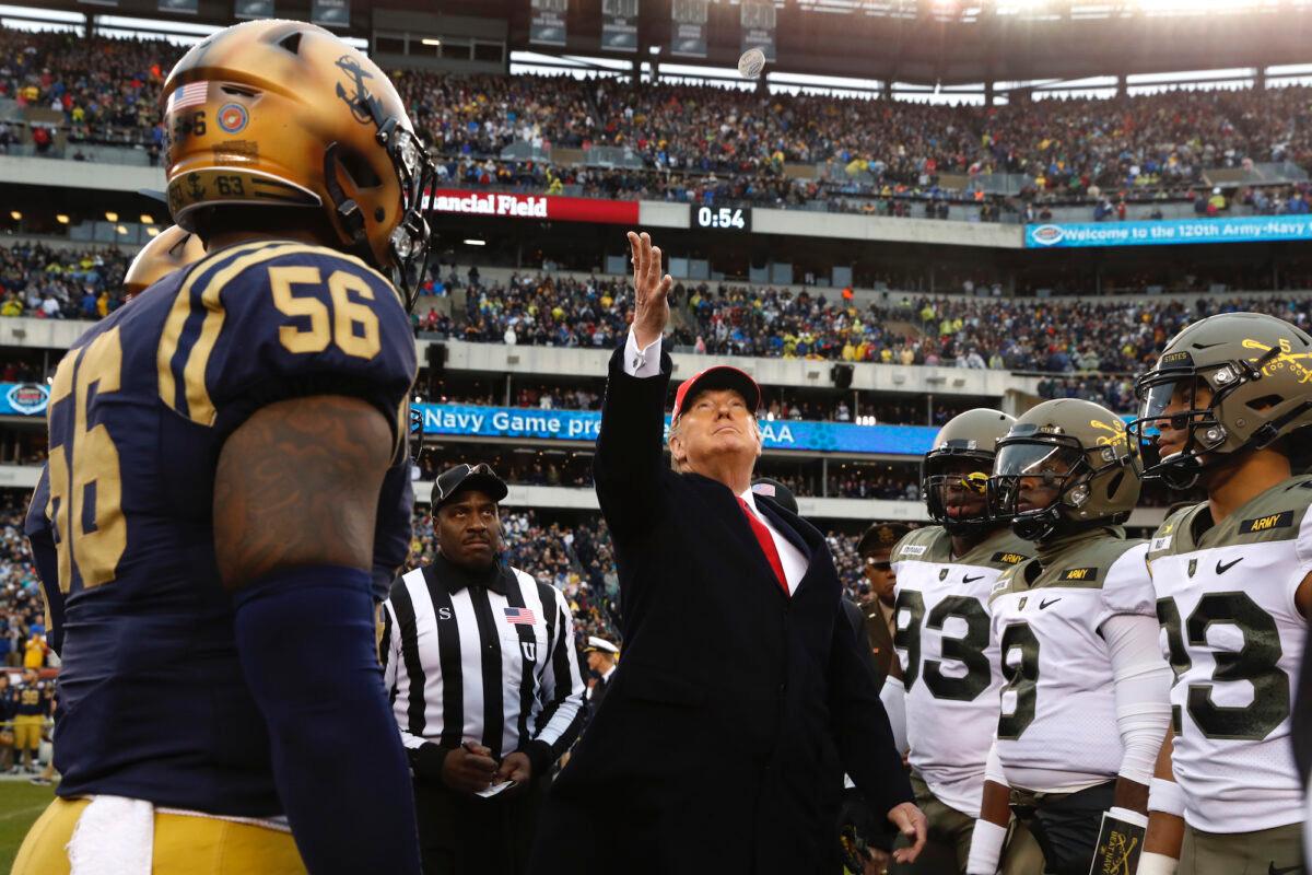 President Donald Trump throws the coin before the start of the Army-Navy college football game in Philadelphia, Saturday, Dec. 14, 2019. (AP Photo/Jacquelyn Martin)
