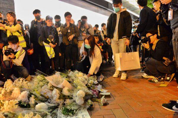People lay down flowers at a memorial service outside of a local shopping mall Pacific Place in Admiralty, Hong Kong, on Dec. 15, 2019. (Sung Pi Lung/The Epoch Times)