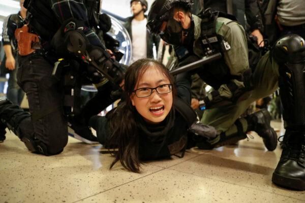 Police officers detain a protester during a demonstration inside a mall in Hong Kong on Dec. 15, 2019. (Reuters/Danish Siddiqui)