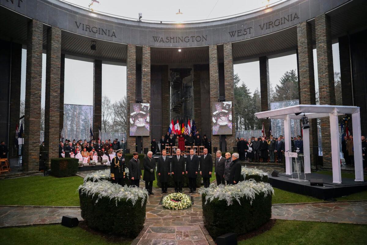 U.S. Secretary of Defense Mark Esper, second left, German President Frank-Walter Steinmeier, third left, Luxembourg's Grand Duke Henri, fourth left, Belgium's King Philippe, fifth left, Poland's President Andrej Duda, sixth left, European Council President Charles Michel, fourth right, and other authorities stand up during a minute of silence during a ceremony to commemorate the 75th anniversary of the Battle of the Bulge at the Mardasson Memorial in Bastogne, Belgium, on Monday, Dec. 16, 2019. (Francisco Seco/AP)