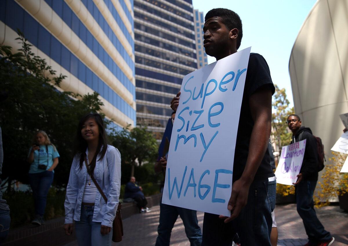 Protestors stage a demonstration outside of the Oakland Chamber of Commerce in Oakland, Calif., on July 8, 2014. (Justin Sullivan/Getty Images)
