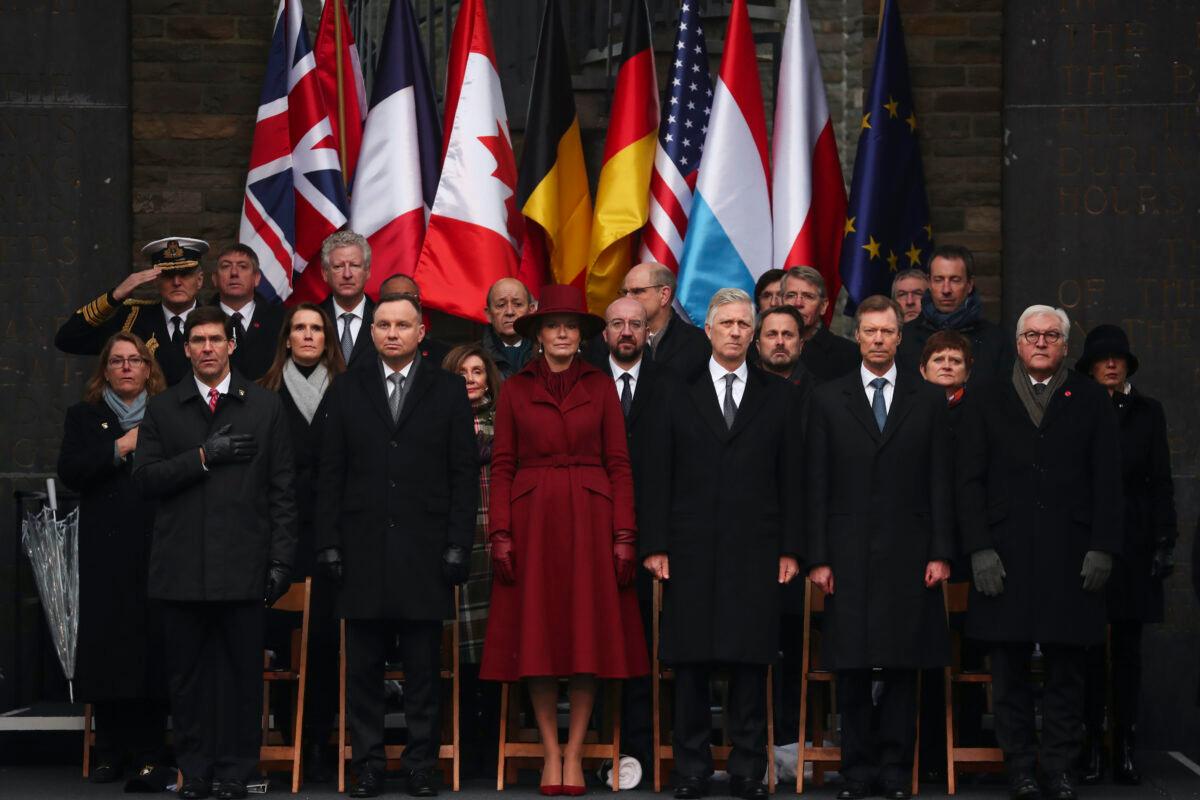 U.S. Secretary of Defense Mark Esper, Poland's President Andrej Duda, Belgium's Queen Mathilde, Belgium's King Philippe, Luxembourg's Grand Duke Henri, German President Frank-Walter Steinmeier, front row from left, and Leah Esper, spouse of Mark Esper, Belgium's Prime Minister Sophie Wilmes, U.S. Speaker of the House Nancy Pelosi, European Council President Charles Michel and Luxembourg's Prime Minister Xavier Bettel, second row from left, and other authorities listen to national anthems during a ceremony to commemorate the 75th anniversary of the Battle of the Bulge at the Mardasson Memorial in Bastogne, Belgium, on Monday, Dec. 16, 2019. (Francisco Seco/AP)