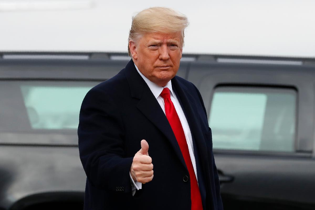 President Donald Trump makes the thumbs-up sign as he exits a motorcade to board Air Force One at Andrews Air Force Base, Md., en route to Philadelphia to attend the Army-Navy football game, on Dec. 14, 2019. (Jacquelyn Martin/AP Photo)