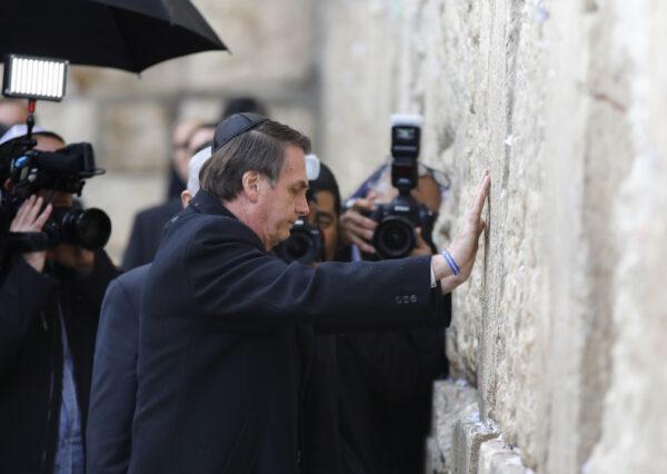 Brazilian President Jair Bolsonaro (foreground) and Israeli Prime Minister Benjamin Netanyahu (background L) pray at the Western wall, the holiest site where Jews can pray, in the Old City of Jerusalem on April 1, 2019. (MENAHEM KAHANA/AFP via Getty Images)