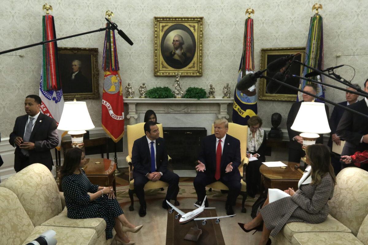 President Donald Trump and First Lady Melania Trump, Guatemalan President Jimmy Morales, and his wife Patricia Marroquin de Morales participate in a meeting in the Oval Office of the White House in Washington on Dec. 17, 2019. (Alex Wong/Getty Images)
