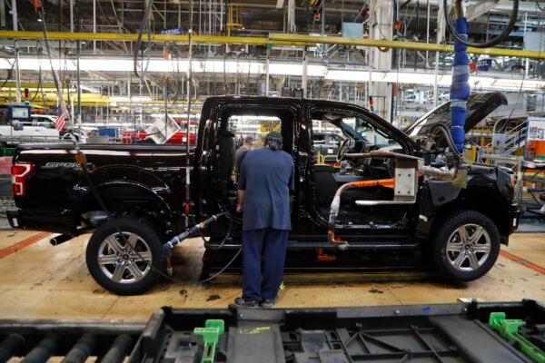 United Auto Workers assemblyman installs seating in a 2018 Ford F-150 truck being assembled at the Ford Rouge assembly plant in Dearborn, Mich., on Sept. 27, 2018. (Carlos Osorio/AP-File)