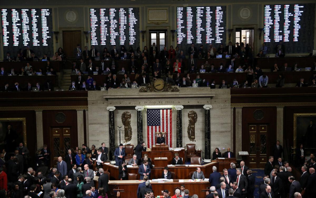 A tote board shows the votes of members of Congress as U.S. Speaker of the House Nancy Pelosi (D-CA) presides over the final of two House of Representatives votes approving two counts of impeachment against U.S. President Donald Trump in the House Chamber of the U.S. Capitol in Washington, on Dec. 18, 2019. (Jonathan Ernst/Reuters)