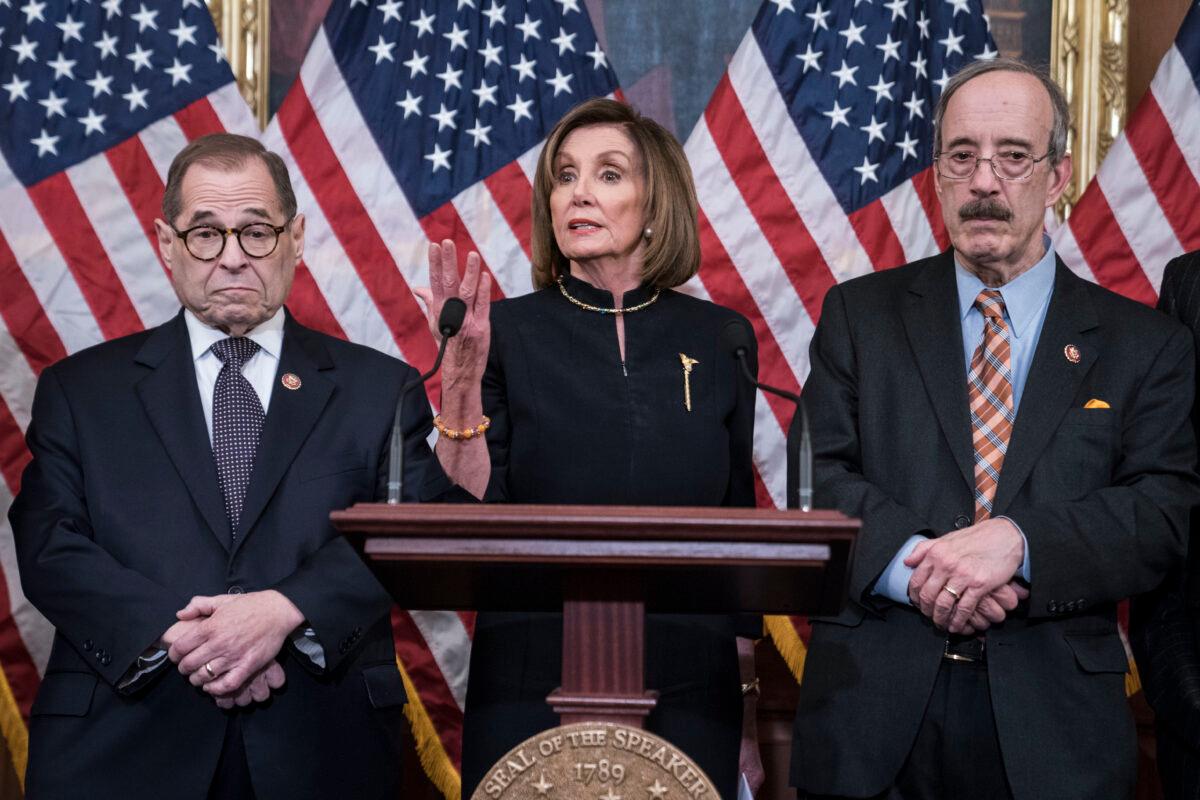 House Speaker Nancy Pelosi (D-Calif.) delivers remarks alongside House Judiciary Chairman Jerry Nadler (D-N.Y.) and House Foreign Affairs Chairman Eliot Engel (D-N.Y.) following the House of Representatives vote to impeach President Donald Trump in Washington on Dec. 18, 2019. (Sarah Silbiger/Getty Images)