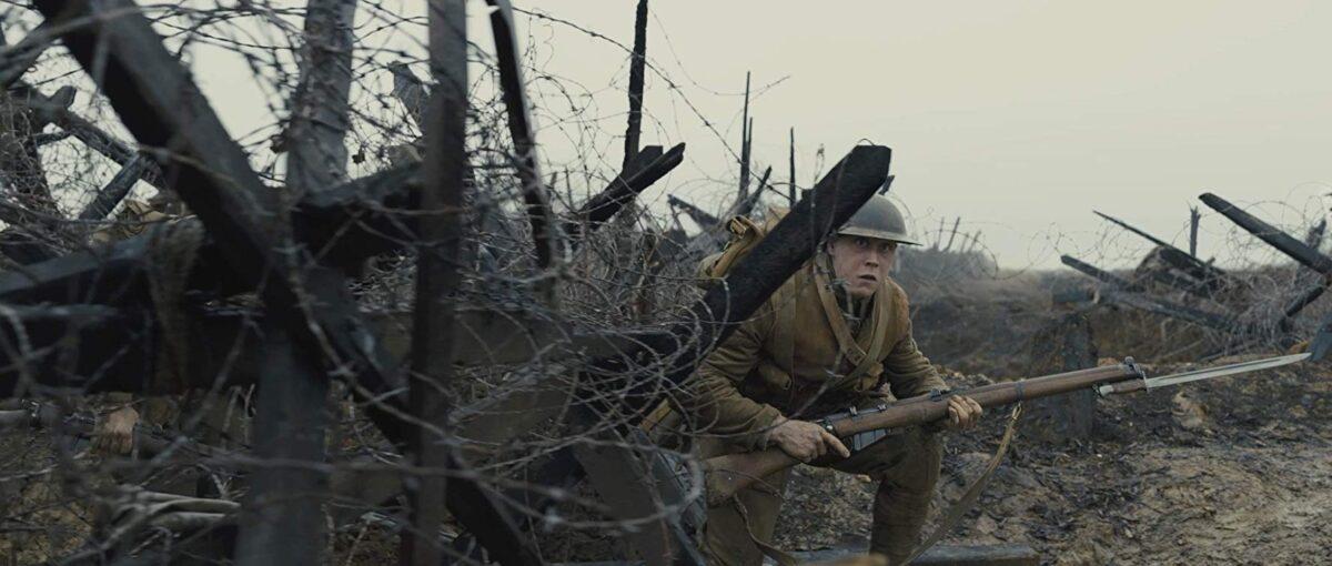 Lance Corporal Schofield (George MacKay) negotiates barbed wire in No Man's Land, in the film "1917." (Universal Pictures)