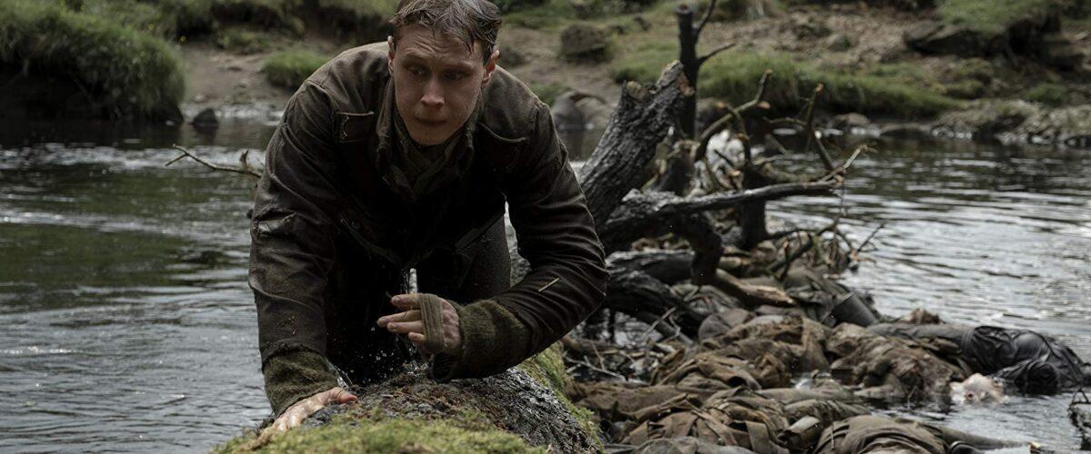 Lance Corporal Schofield (George MacKay) escapes a corpse-filled river, in the film "1917." (Universal Pictures)