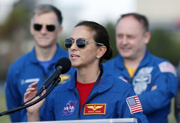 NASA astronaut Nicole Mann speaks as Boeing astronaut Chris Ferguson, left, and NASA astronaut Mike Fincke listen during a press conference at the Kennedy Space Center, in Cape Canaveral, Fla., on Dec. 19, 2019. (AP Photo/Terry Renna/AP Photo)