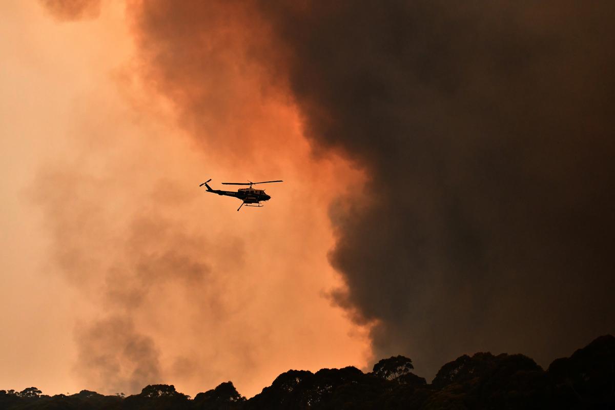 A helicopter is seen during a bushfire near Bilpin, 90 km north west of Sydney, Australia, Dec. 19, 2019. (AAP Image/Mick Tsikas/via Reuters)