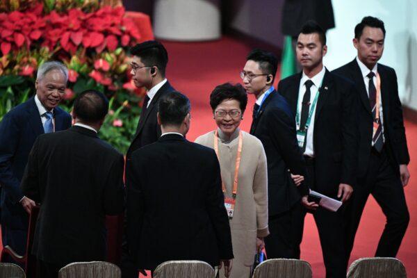 Hong Kong's Chief Executive Carrie Lam (C) and her husband Lam Siu-por (L) arrive for the inauguration ceremony of Macau's new chief executive Ho Iat-Seng in Macau on Dec. 20, 2019. (Philip Fong/AFP via Getty Images)
