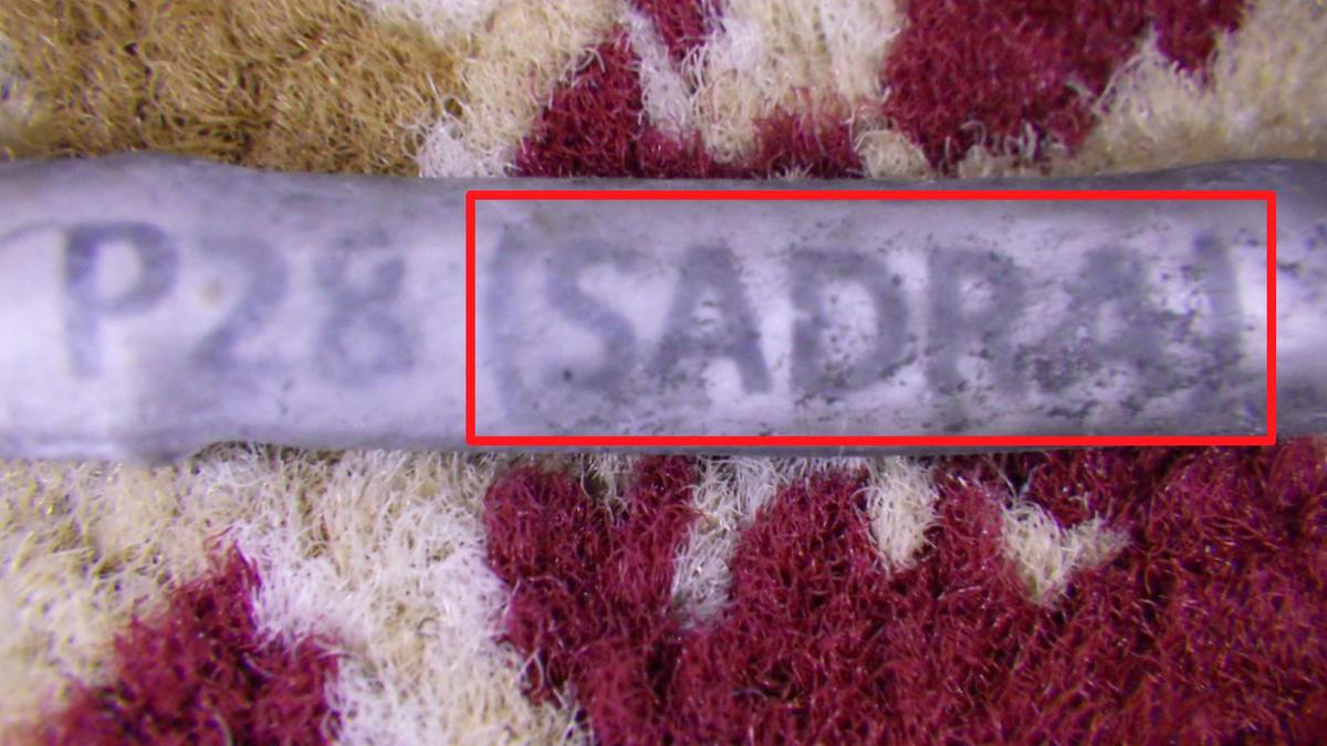 The name of a company believed by U.S. government authorities to be associated with Iran, SADRA, is seen on a wiring harness label from the wreckage of the September 14, 2019 attack on an Aramco oil facility in Saudi Arabia in this handout image provided by a U.S. government source. (U.S. govt/Handout via Reuters)