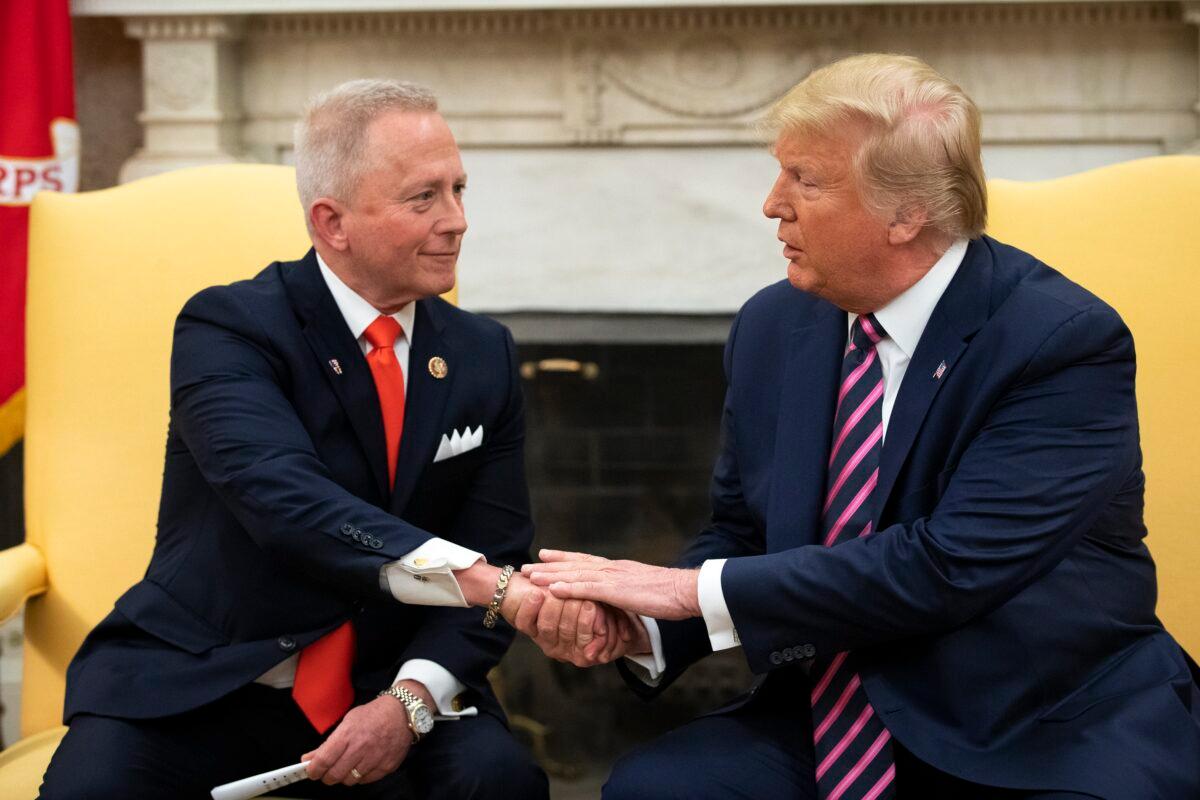Rep. Jeff Van Drew (R-N.J.), left, meets with President Donald Trump in the Oval Office of the White House in Washington on Dec. 19, 2019. Van Drew left the Democratic Party for the GOP over the former's shift away from moderates.(Drew Angerer/Getty Images)