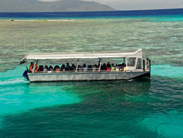 Viewing the Great Barrier Reef on a glass-bottom boat is a popular activity for tourists. (Fred J. Eckert)