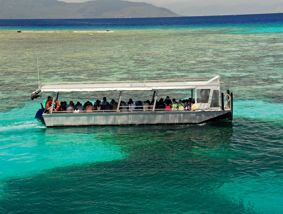 Viewing the Great Barrier Reef on a glass-bottom boat is a popular activity for tourists. (Fred J. Eckert)