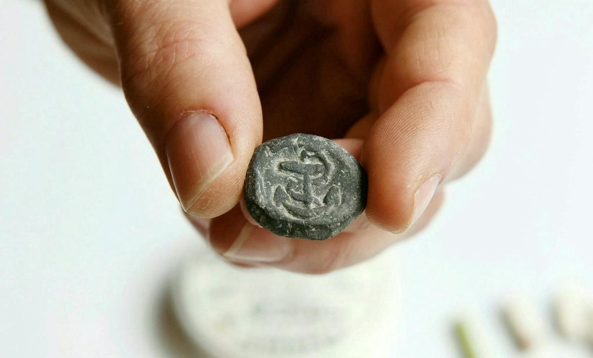 The lead token with an anchor imprinted on it. (SWNS)