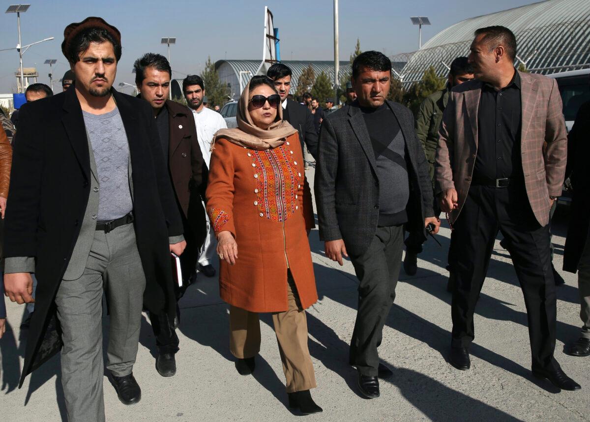 Hawa Alam Nuristani, chief of Election Commission of Afghanistan, center, leaves after a press conference at the Independent Election Commission office in Kabul, Afghanistan, Sunday, Dec. 22, 2019. (Rahmat Gul/AP)