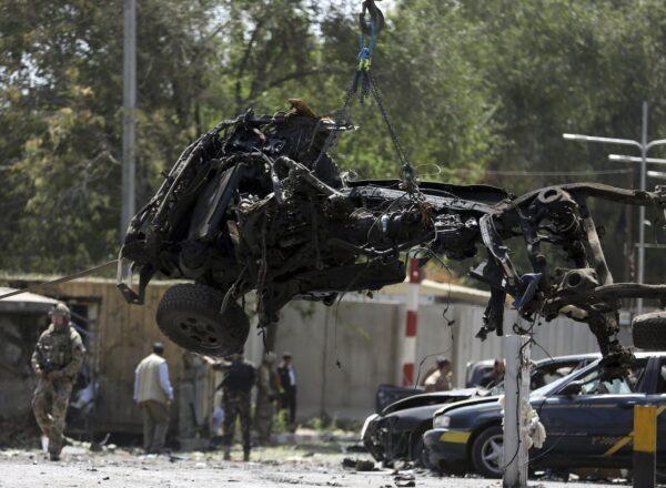 Resolute Support (RS) forces remove a destroyed vehicle after a car bomb explosion in Kabul, Afghanistan on Sept. 5, 2019. (Rahmat Gul/AP Photo)