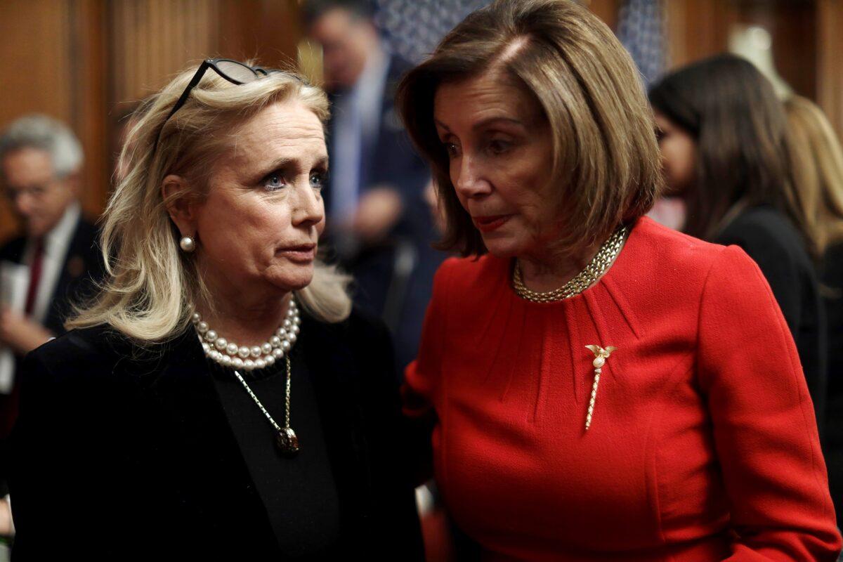 Rep. Debbie Dingell (D-Mich.), left, speaks with House Speaker Nancy Pelosi (D-Calif.) after an event at the Rayburn Room of the U.S. Capitol in Washington on Dec. 19, 2019. (Alex Wong/Getty Images)