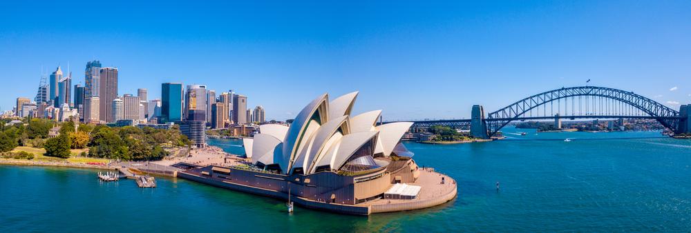 The Sydney Opera House, with its white sculptured sails, stands on a point that extends into the city’s magnificent harbor. (Shutterstock)