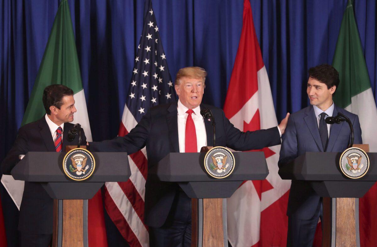President Donald Trump with Mexico's President Enrique Pena Nieto, left, and Canada's Prime Minister Justin Trudeau before signing a new United States-Mexico-Canada Agreement (USMCA) that replaced the NAFTA trade deal during a ceremony on Nov. 30, 2018. (Martin Mejia/AP Photo)