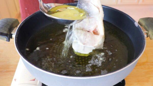 Carefully ladle hot oil over the fish, to set its shape. (CiCi Li)