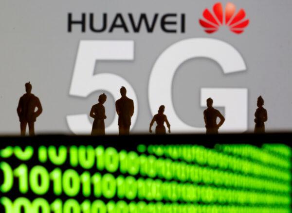 Small toy figures are seen in front of a displayed Huawei and 5G network logo in this illustration picture on March 30, 2019. (Dado Ruvic/Reuters)