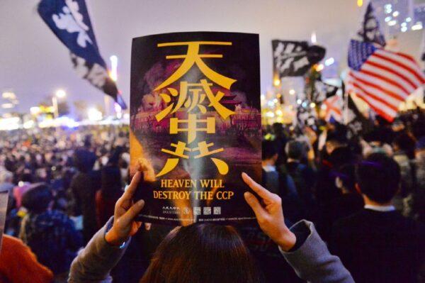 A protester holds a poster produced by The Epoch Times that reads: "Heaven Will Destroy the CCP," in a rally in Chater Garden, Hong Kong, on Dec. 23, 2019. (Sung Pi-lung/The Epoch Times)