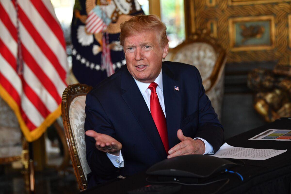 President Donald Trump answers questions from reporters after making a video call to the troops stationed worldwide at the Mar-a-Lago estate in Palm Beach Florida, on Dec. 24, 2019. (Nicholas Kamm/AFP via Getty Images)