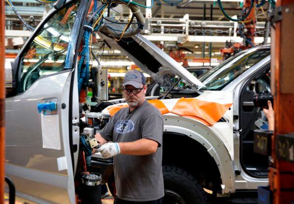 An employee works on the assembly line for the Ford 2018 and 2019 F-150 truck at the Ford Motor Company's Rouge Complex in Dearborn, Michigan, on Sept. 27, 2018. (Jeff Kowalsky/AFP via Getty Images)