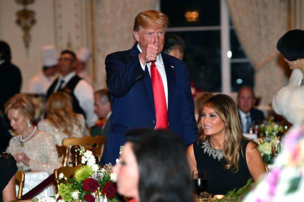 President Donald Trump and First Lady Melania Trump attend a Christmas Eve dinner with his family at Mar-A-Lago in Palm Beach, Fla., on Dec. 24, 2019. (Nicholas Kamm/AFP via Getty Images)