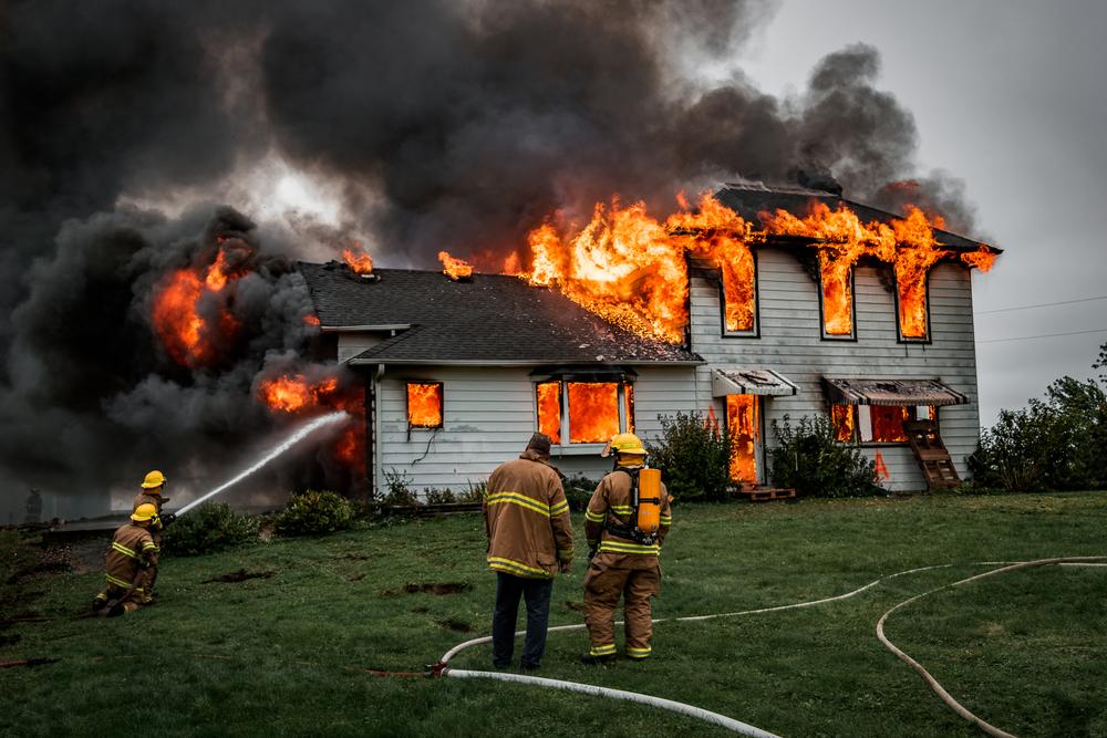 Illustration - Shutterstock | <a href="https://www.shutterstock.com/image-photo/fire-fighters-putting-out-house-697223872">Sean Thomforde</a>