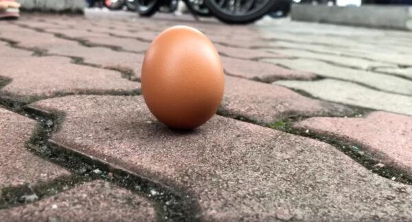 An egg is seen on the ground in Shah Alam, Kuala Lumpur, Malaysia, on Dec. 26, 2019 in this screengrab obtained from a social media video. (Hakeem Maarof via Reuters)